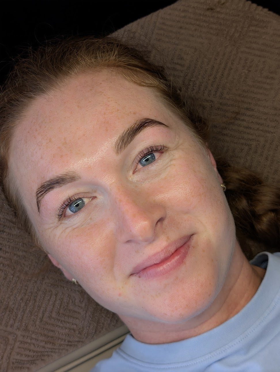 Client with softly shaped brows smiling